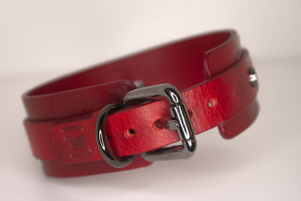 Back view of the 'Blood Moon' red leather BDSM collar, emphasizing the detailed craftsmanship, black buckle, and adjustable strap.