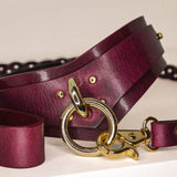 Close-up of Bordeaux Italian leather BDSM collar, highlighting the gold-tone hardware and craftsmanship.