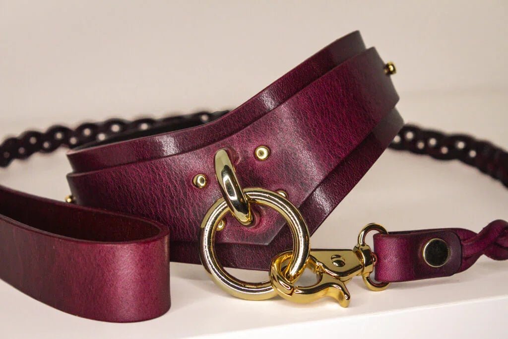 Close-up of Bordeaux Italian leather BDSM collar, highlighting the gold-tone hardware and craftsmanship.