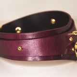 Side view of a submissive Bordeaux Italian leather BDSM collar with a gold-tone buckle and loop.