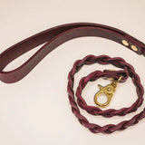 Coiled handmade Bordeaux Italian leather BDSM leash with luxurious gold-tone hardware.