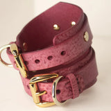 Hand wearing a Desert Rose Italian leather BDSM cuff, connected by a luxurious gold-tone chain.