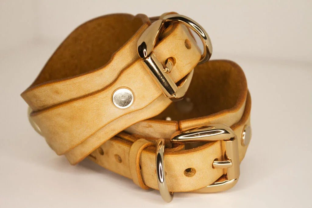 Golden Hour leather BDSM cuffs back detail, rolled and buckled with gold-tone hardware.