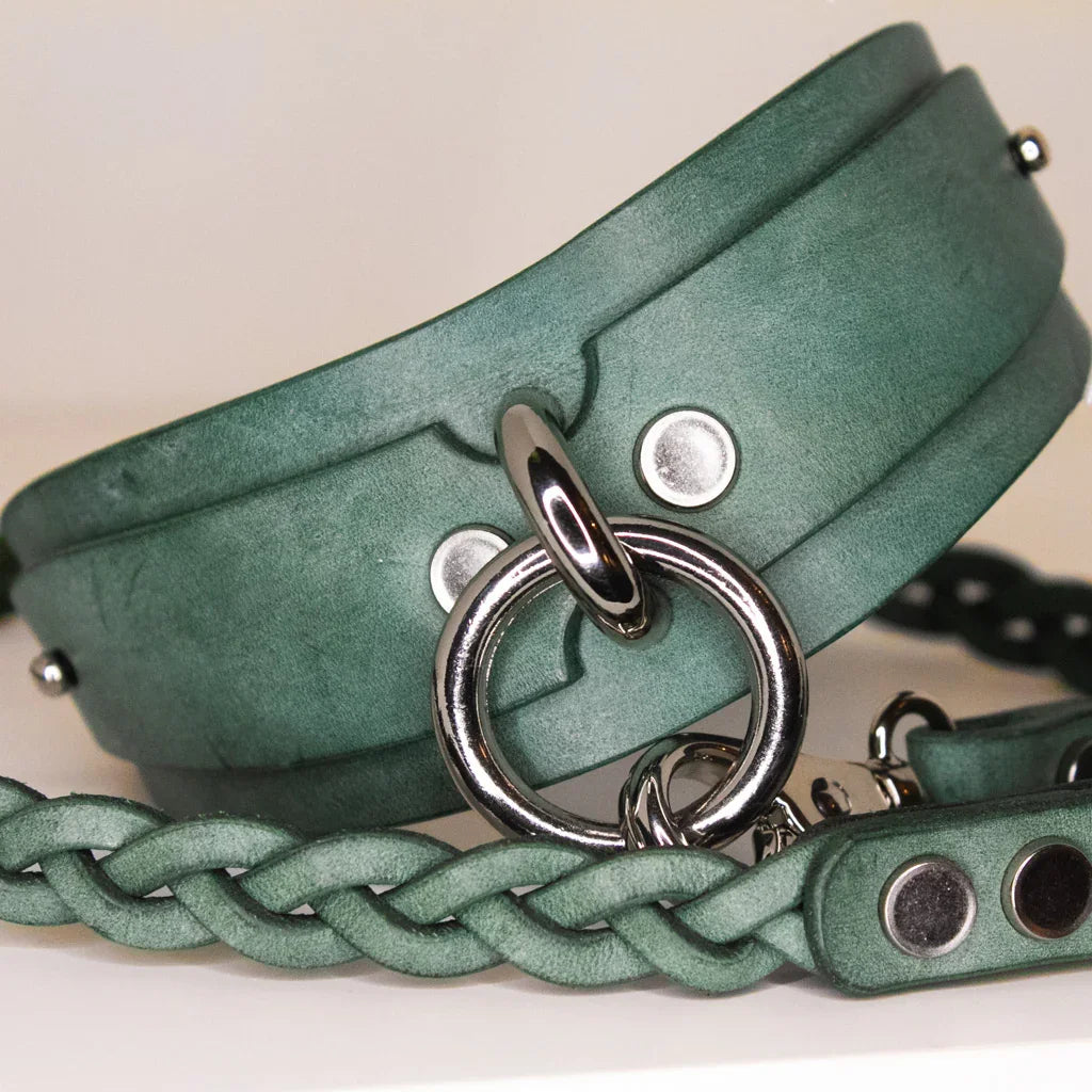 Yucca green leather BDSM collar with silver-tone O-rings linked to a matching braided leash.