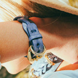 woman wearing blue luxury leather cowboy core bracelet outside closeup