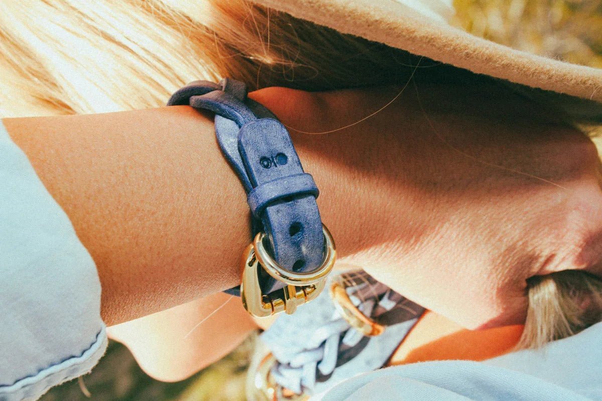 woman wearing blue luxury leather cowboy core bracelet outside closeup