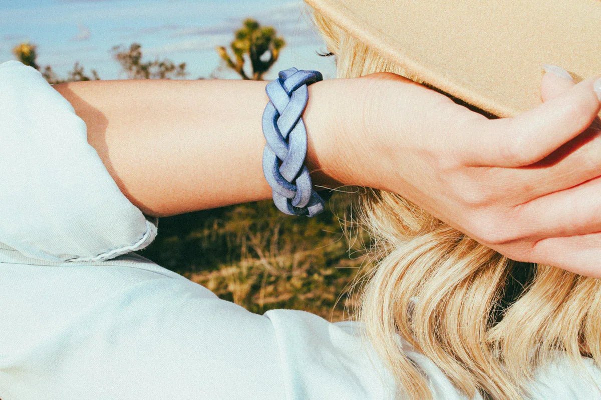 woman wearing blue luxury leather bracelet outside closeup