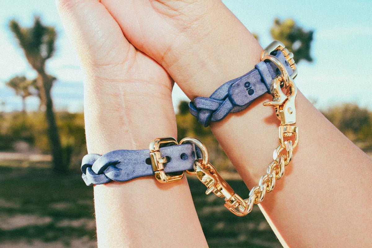 woman wearing blue luxury leather bracelets with gold hardware