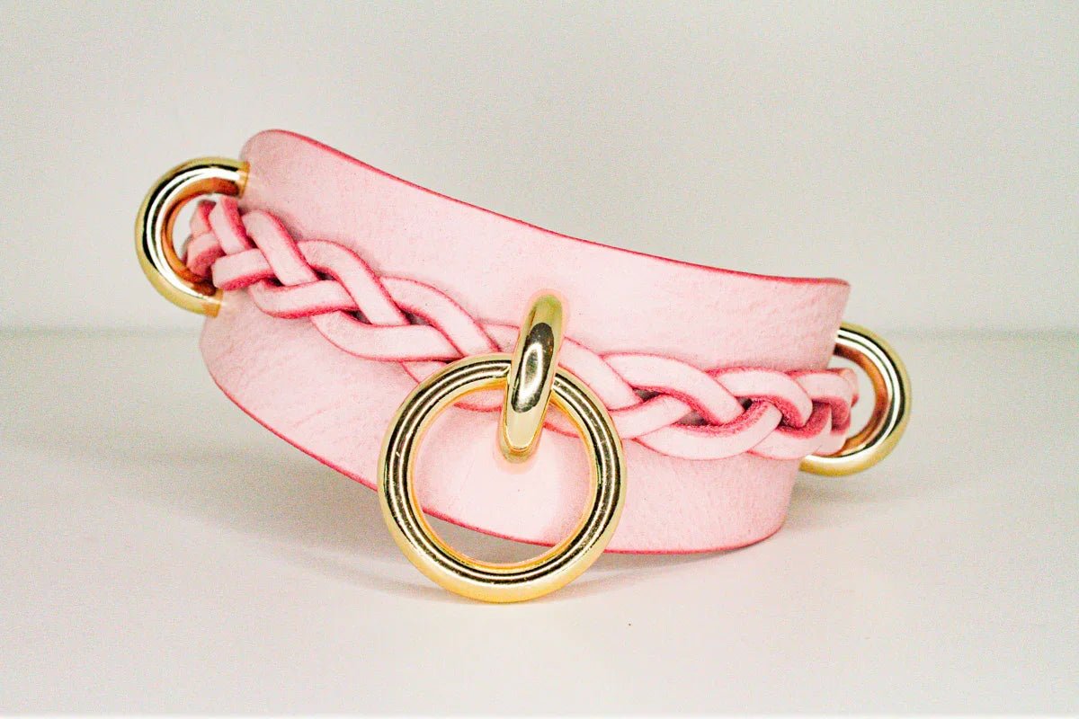Pink custom leather day collar with braided detail and gold metal rings, high-quality leather cuffs
