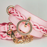 Pink leather day collar and leather wrist cuffs with gold hardware and braided details