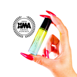 Hand with red nails holding Neon Coyotes Brat Tamer perfume bottle, XMA 2026 award nominee