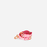 Pink leather day collar with rose gold hardware and matching leather wrist cuffs on white background