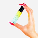 woman holding Brat Tamer pocket perfume bdsm