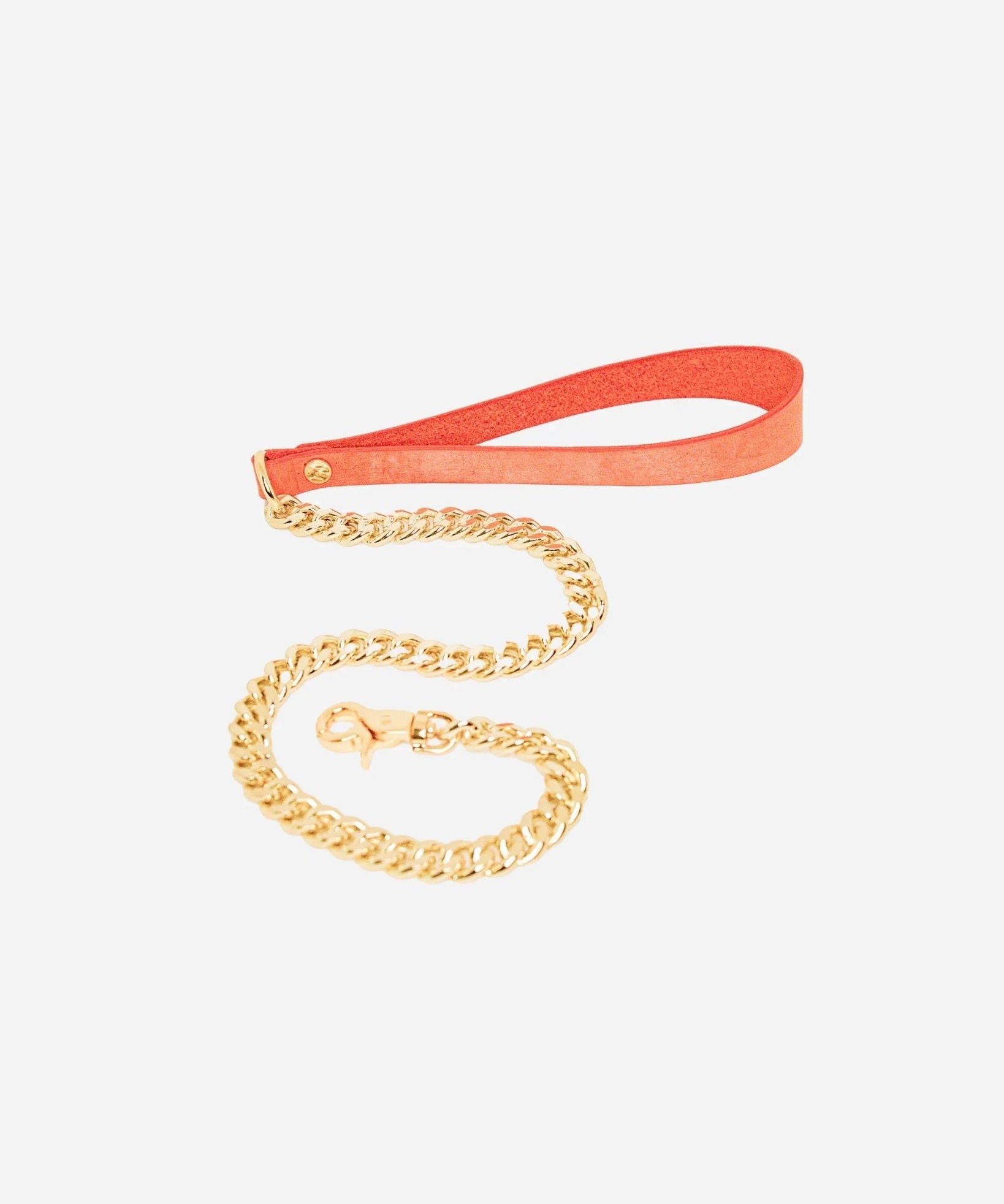 Orange leather wrist cuffs with gold chain leash on white background, featuring custom leather design.