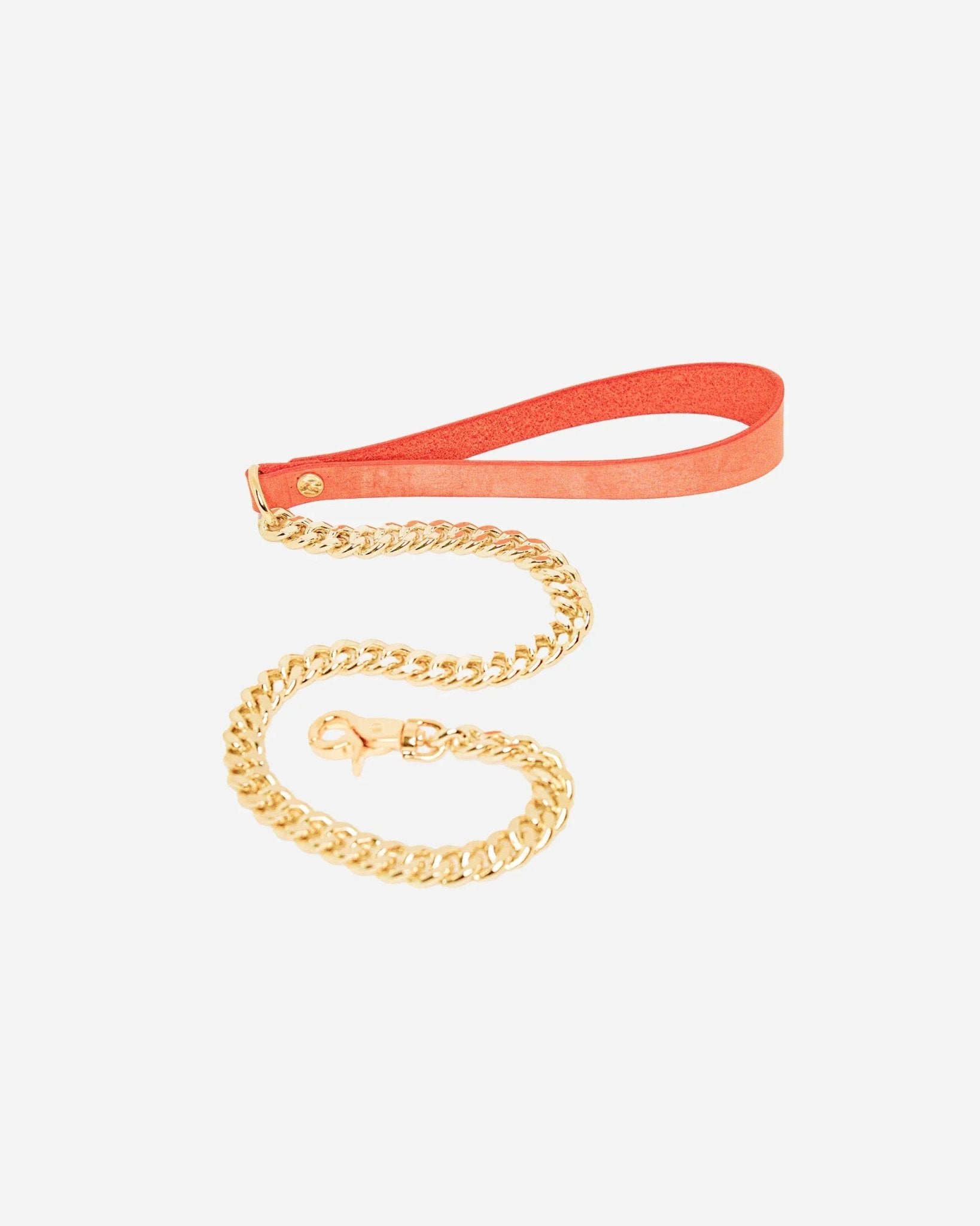 Orange leather wrist cuffs with gold chain leash on white background, featuring custom leather design.