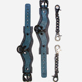 Overhead view of custom Italian leather cuffs with black hardware and metal chain connectors on white background