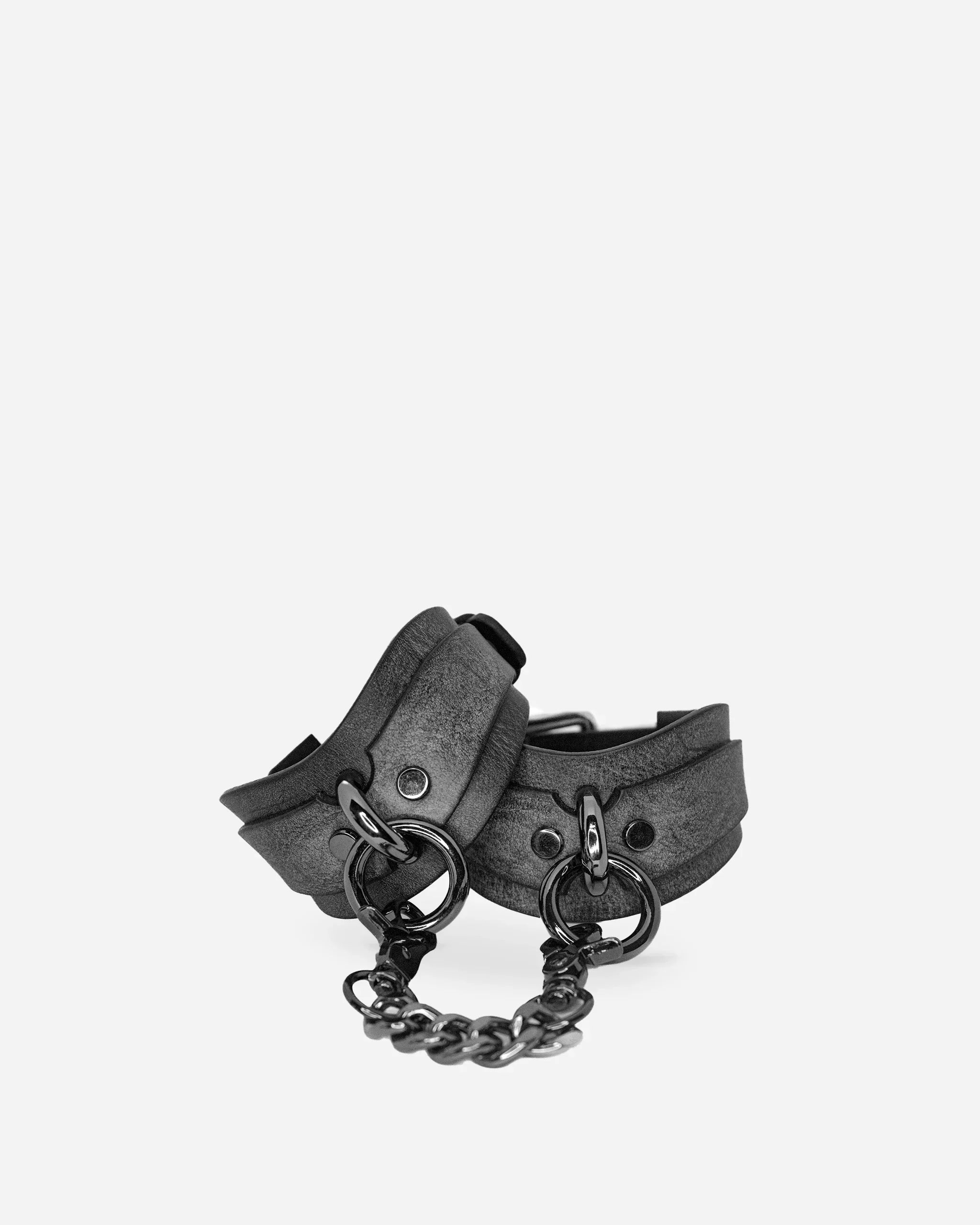 Pair of gray leather cuffs connected by black metal chain, featuring full-grain Italian leather construction
