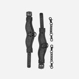 Black leather cuffs with curved design and metal rings, paired with two black metal chain connectors