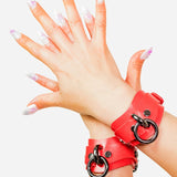 custom red leather cuffs with black rings on a white background