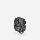 Grey leather wrist cuffs with black metal O-rings on white background, custom leather cuffs