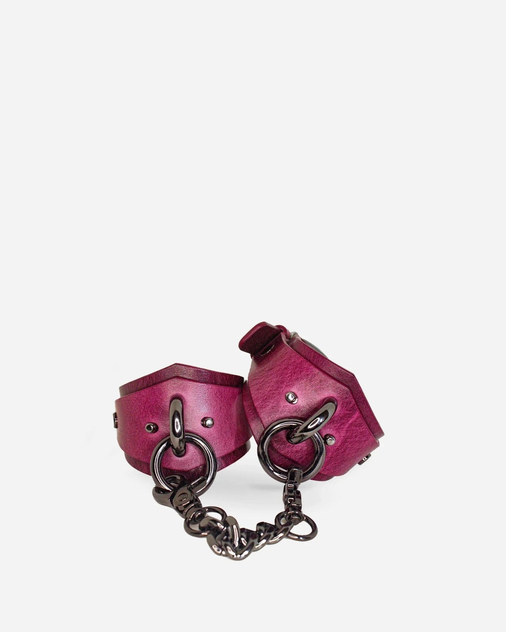Pair of purple leather wrist cuffs connected by black chain links, featuring metal rings and rivets