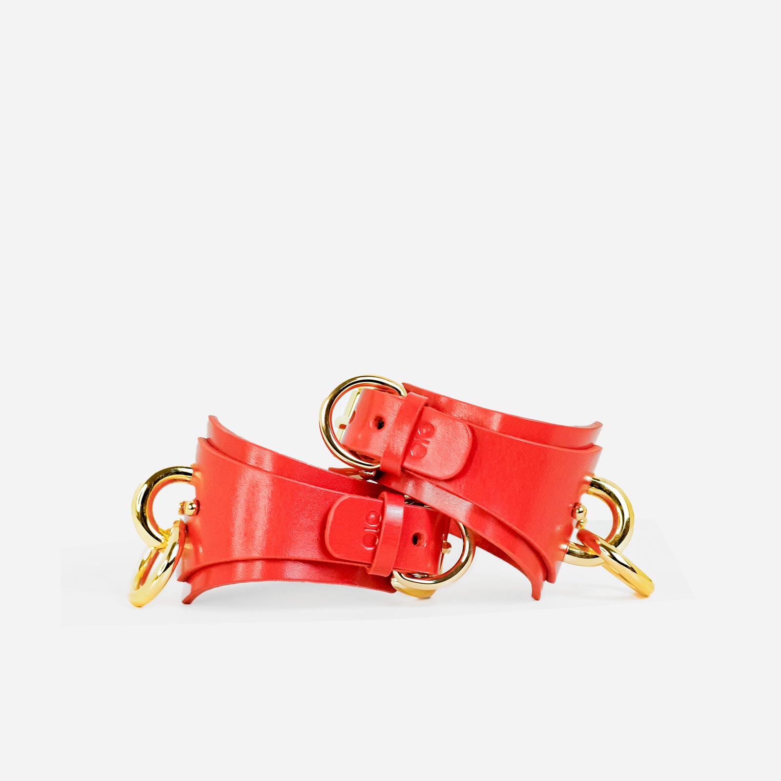 custom red leather cuffs with gold hardware