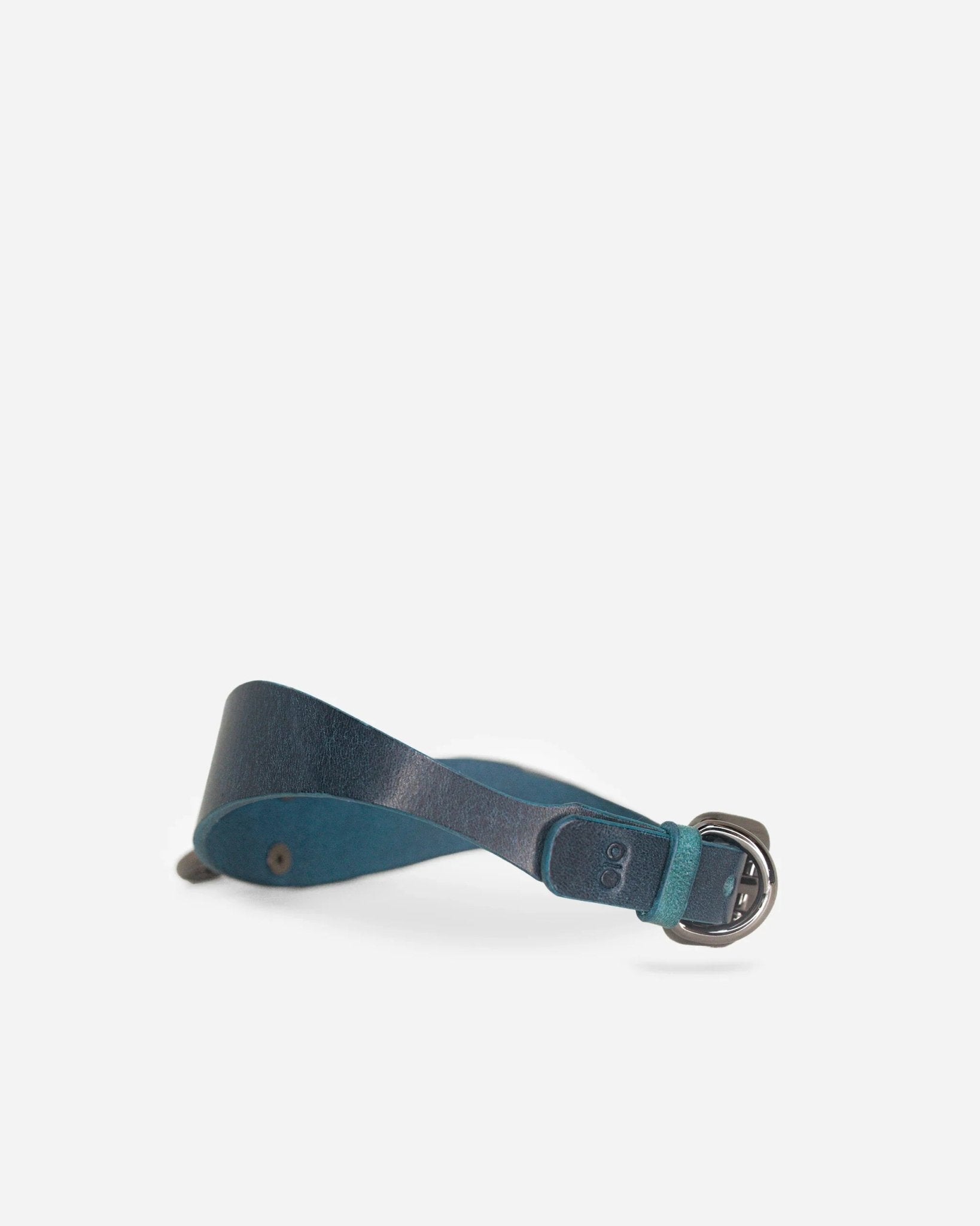 Dark teal leather day collar with silver buckle, soft texture, and minimalist design on white background