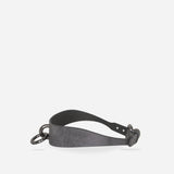 Black leather day collar with metal O-ring and buckle, minimalist design on white background