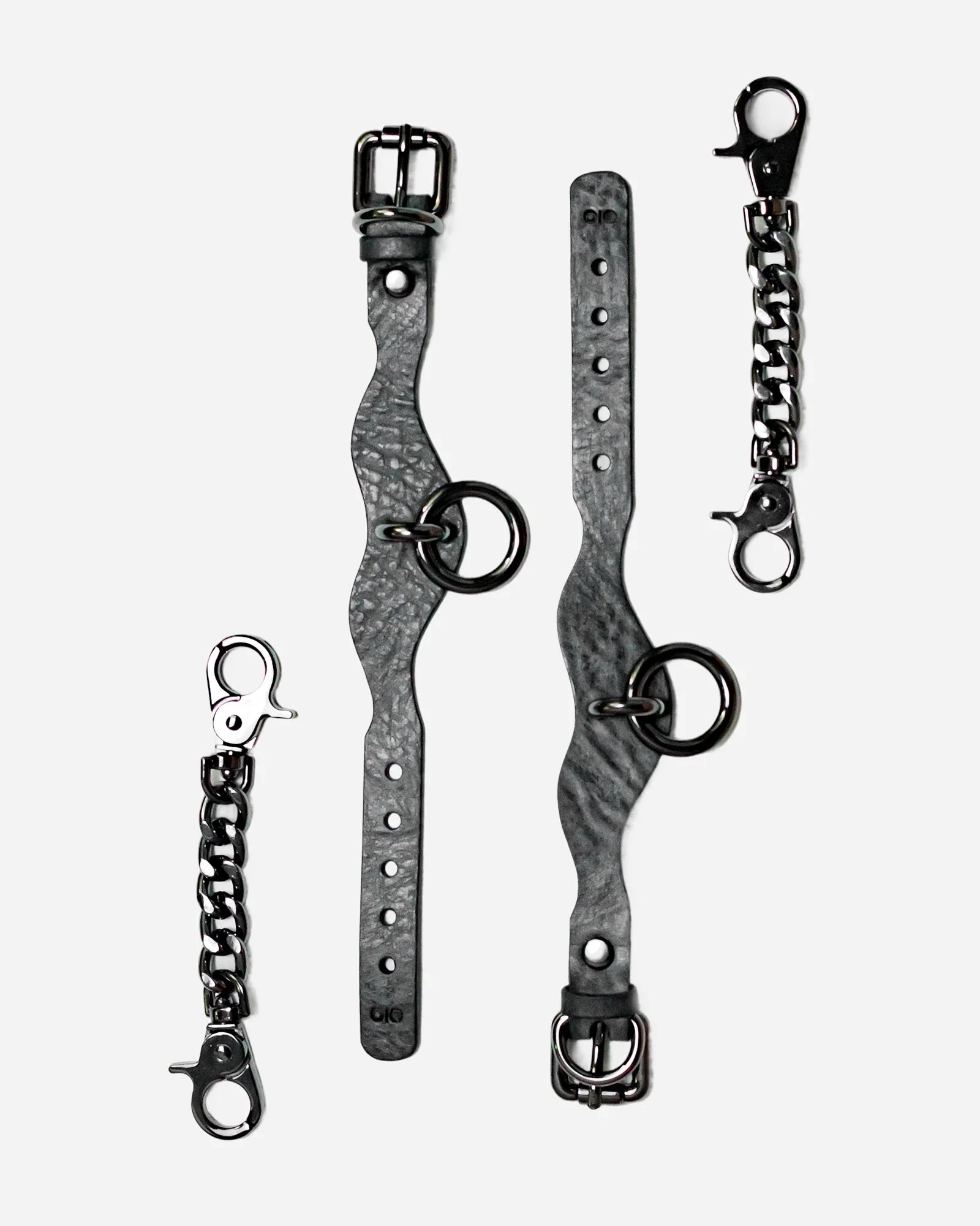 Gray textured leather wrist cuffs with black metal rings, buckles, and detachable chain connectors