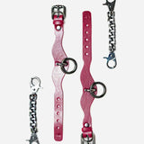 Pair of Bordeaux leather cuffs with metal rings and two detachable silver chain connectors for wrist cuffs