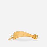 Golden hour leather wrist cuff with buckle and rings on white background, luxury leather cuffs