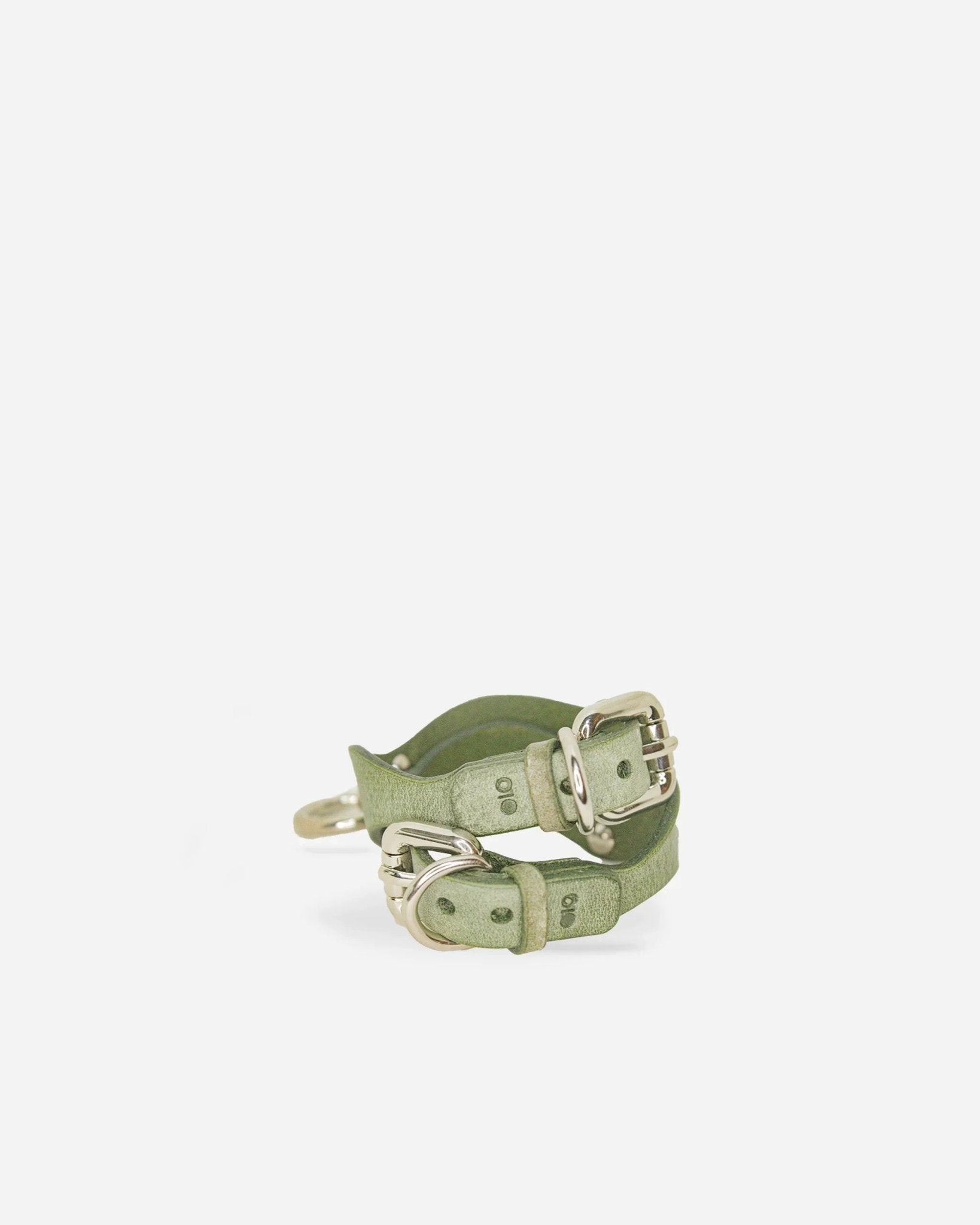 Orbit Pistachia green full-grain leather wrist cuffs with silver buckles on white background