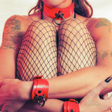 woman wearing red bdsm collar and cuffs