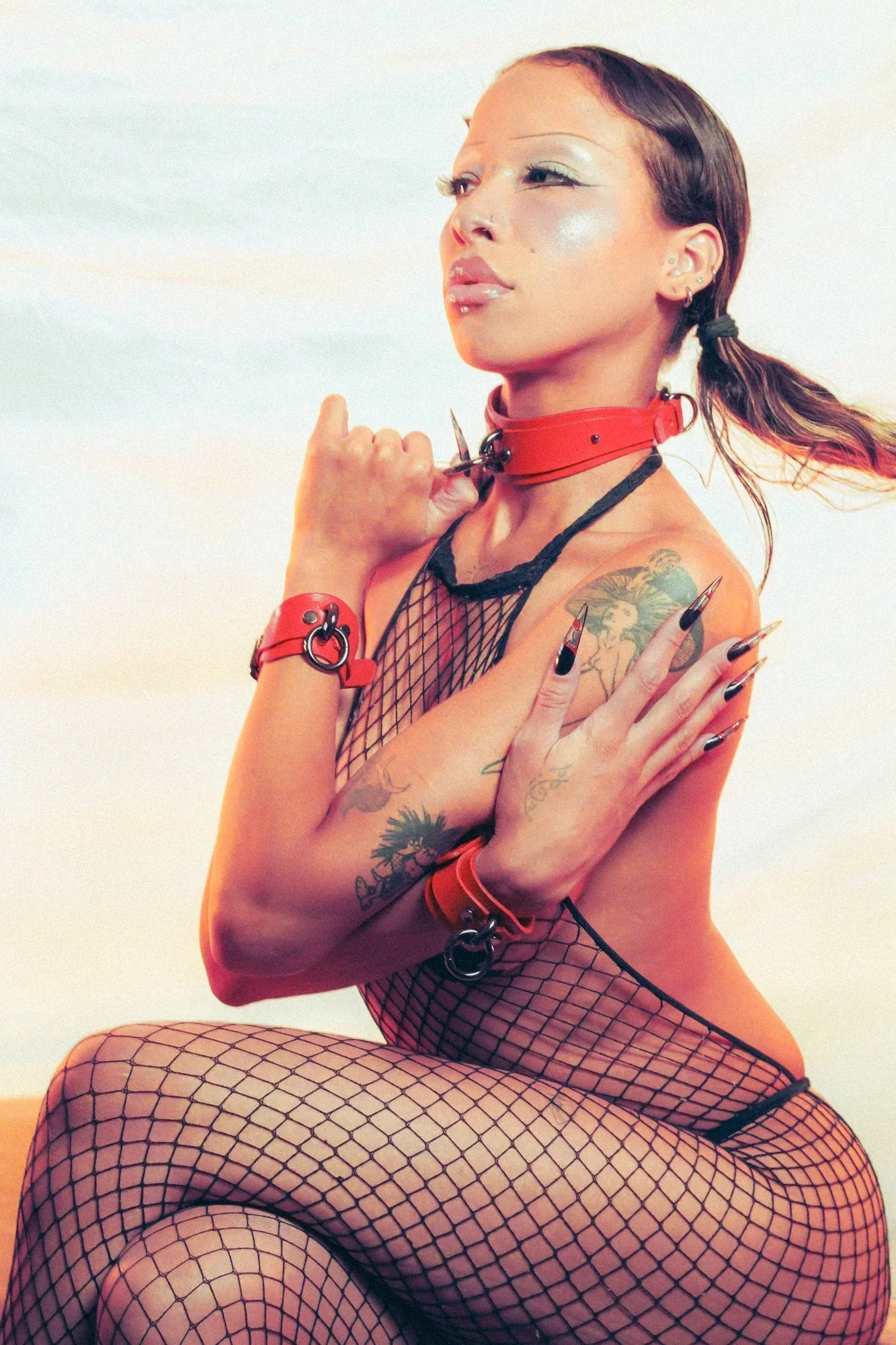 woman wearing red bdsm collar and cuffs